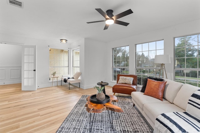 living room with ceiling fan and light wood-type flooring