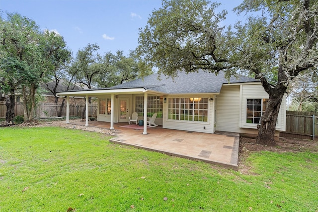 back of house featuring a patio area and a lawn