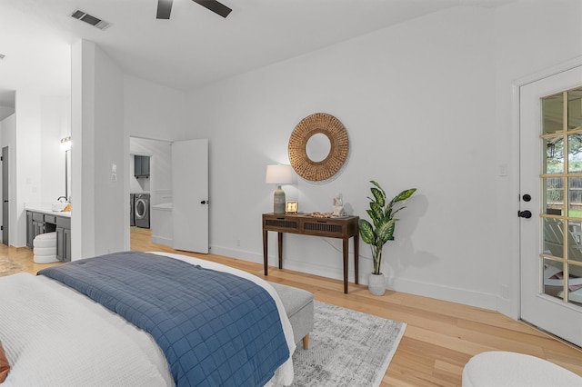 bedroom with ceiling fan, ensuite bathroom, light hardwood / wood-style floors, and washer / clothes dryer