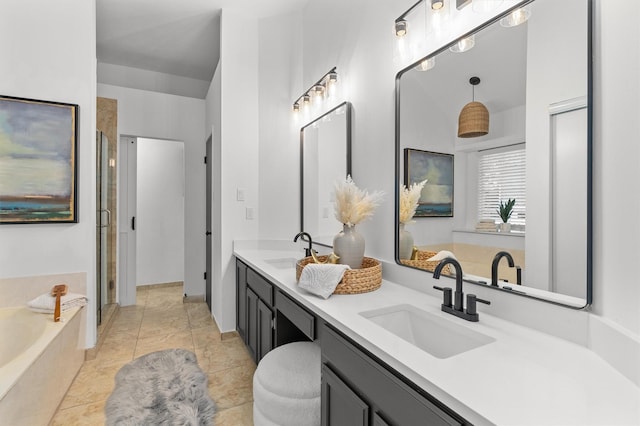 bathroom with independent shower and bath, tile patterned floors, and vanity