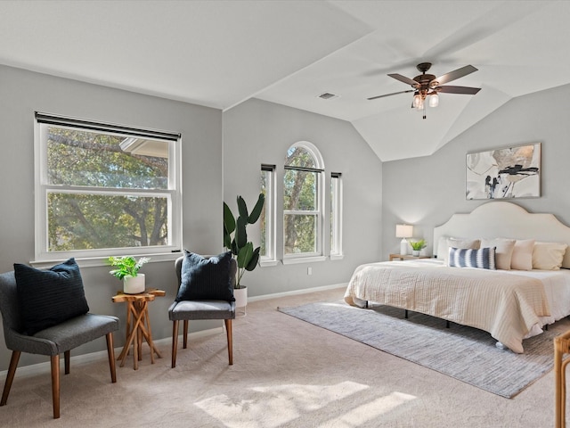 carpeted bedroom with ceiling fan and vaulted ceiling