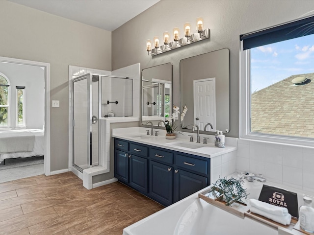 bathroom with a shower with shower door and vanity