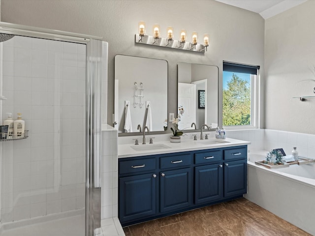 bathroom with shower with separate bathtub and vanity