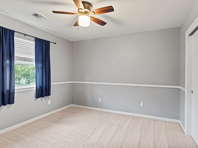 empty room featuring light carpet and ceiling fan