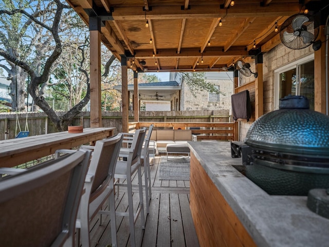 wooden deck with an outdoor hangout area and ceiling fan