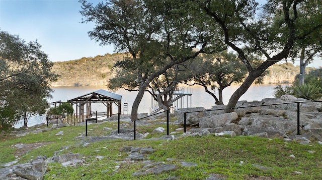 view of yard with a water and mountain view and a gazebo