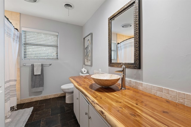 bathroom featuring toilet and vanity