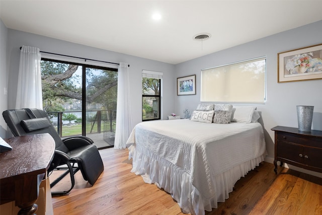 bedroom with light hardwood / wood-style floors and access to exterior