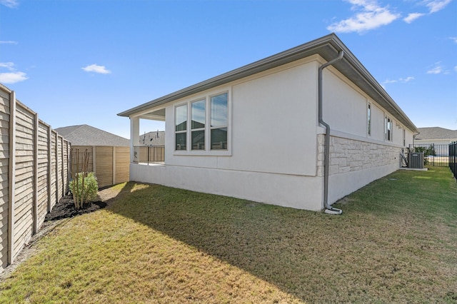 view of home's exterior with central AC and a lawn