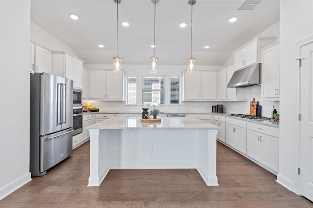 kitchen with hanging light fixtures, white cabinetry, stainless steel appliances, and a center island