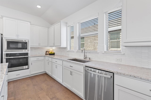 kitchen featuring white cabinets, appliances with stainless steel finishes, and sink