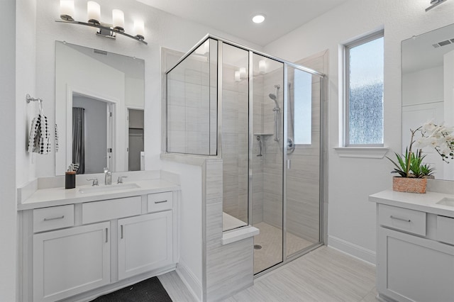 bathroom with walk in shower and vanity