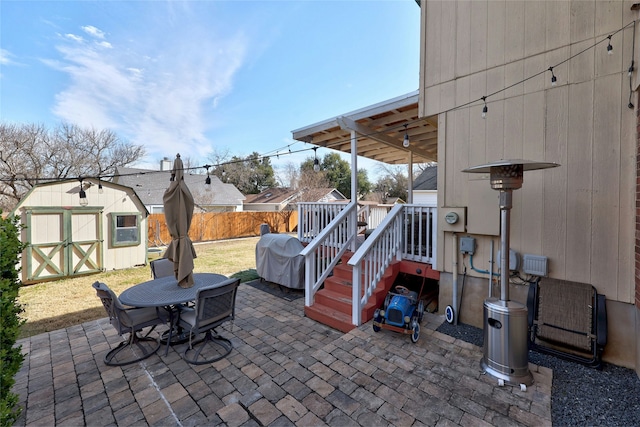 view of patio featuring area for grilling and a storage shed