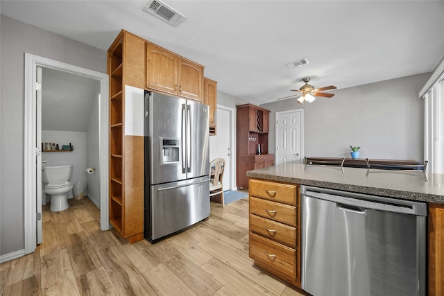 kitchen with ceiling fan, stainless steel appliances, and light hardwood / wood-style floors