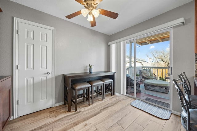 home office with ceiling fan and light wood-type flooring