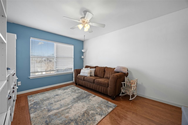 living room featuring ceiling fan and dark hardwood / wood-style flooring