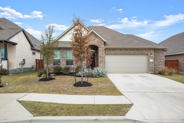 view of front of house with a front yard and a garage