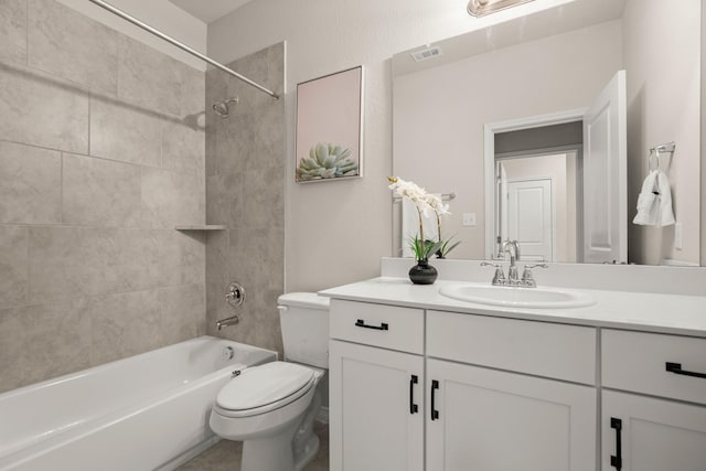 full bathroom with toilet, vanity, and tiled shower / bath