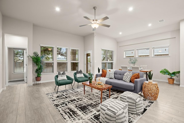 living room featuring ceiling fan, light hardwood / wood-style flooring, and plenty of natural light