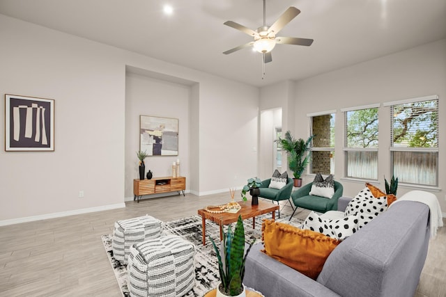 living room featuring ceiling fan and light hardwood / wood-style floors