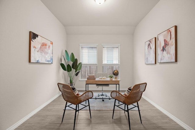 home office featuring lofted ceiling and hardwood / wood-style floors