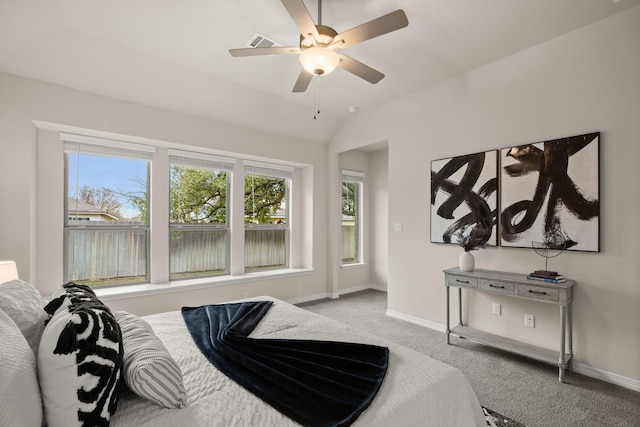 bedroom with ceiling fan, light carpet, vaulted ceiling, and multiple windows