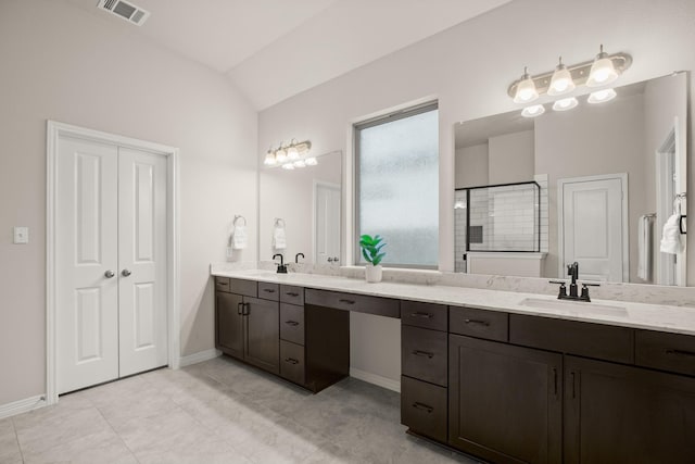 bathroom featuring vaulted ceiling, tile patterned floors, a shower with door, and vanity