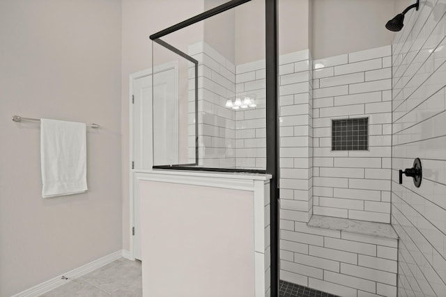 bathroom featuring tile patterned floors and tiled shower