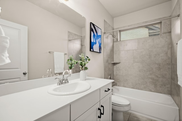 full bathroom with toilet, tile patterned flooring, tiled shower / bath, and vanity