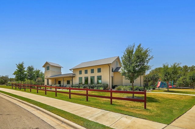 view of front facade with a playground and a front lawn