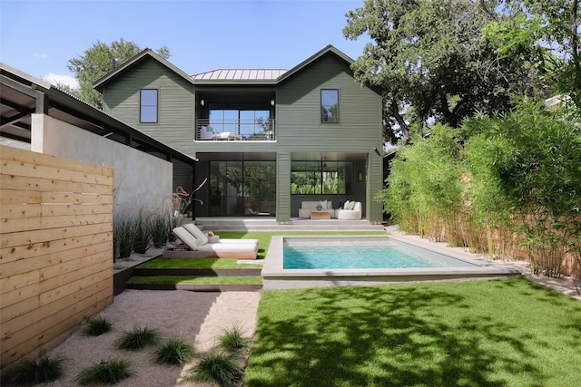 rear view of house featuring an outdoor hangout area, a patio area, and a yard