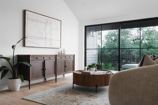 living area with lofted ceiling and light wood-type flooring