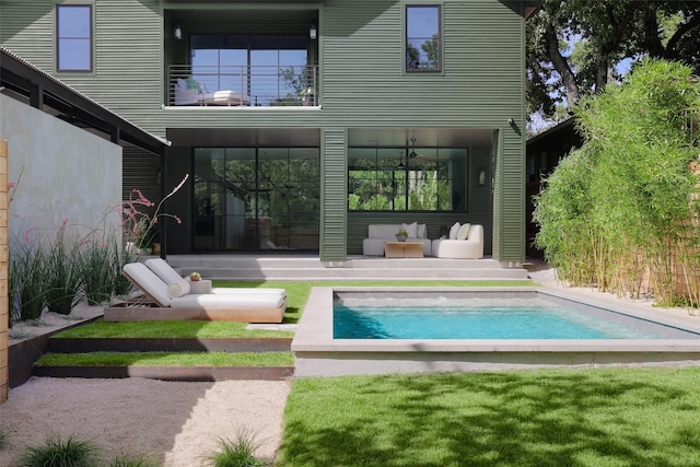 back of house with an outdoor hangout area and a balcony