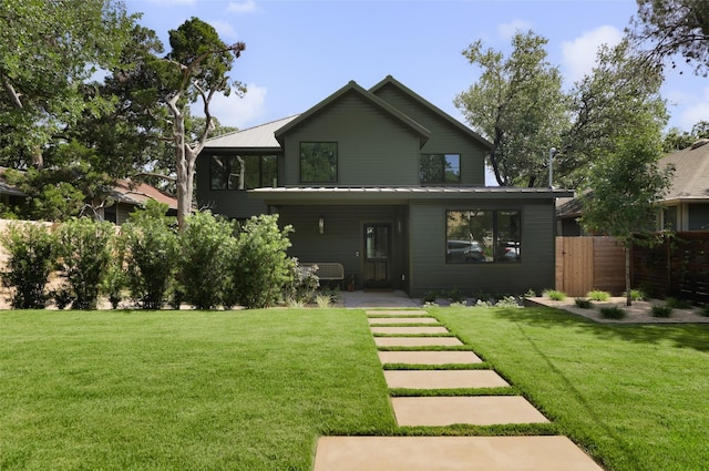 rear view of house with a yard