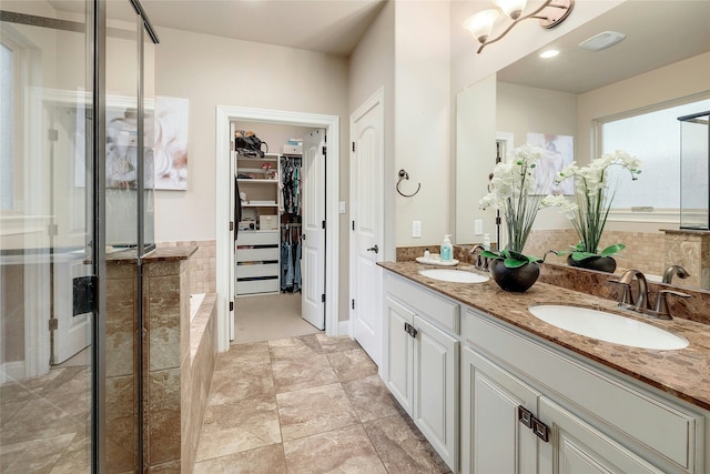 bathroom with vanity and independent shower and bath