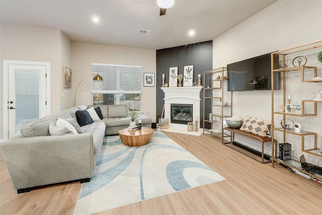 living room featuring ceiling fan and light hardwood / wood-style floors