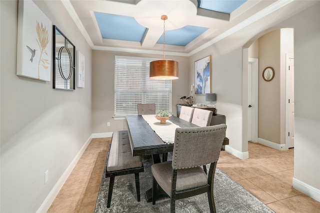 dining space with light tile patterned floors, coffered ceiling, and ornamental molding