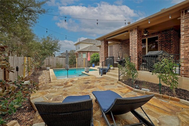 view of pool featuring ceiling fan and a patio