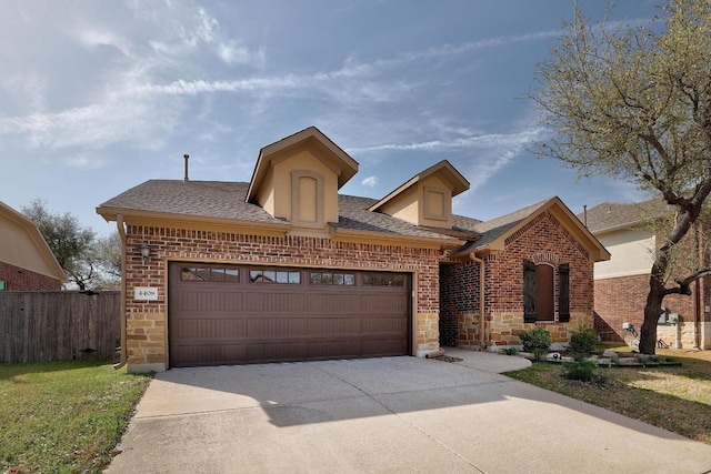 4408 Trinity Woods St, Leander, TX 78641 - view of front facade featuring driveway, an attached garage, brick siding, and stone siding