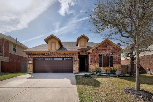 4408 Trinity Woods St, Leander, TX 78641 - view of front of house featuring a shingled roof, brick siding, driveway, and a garage