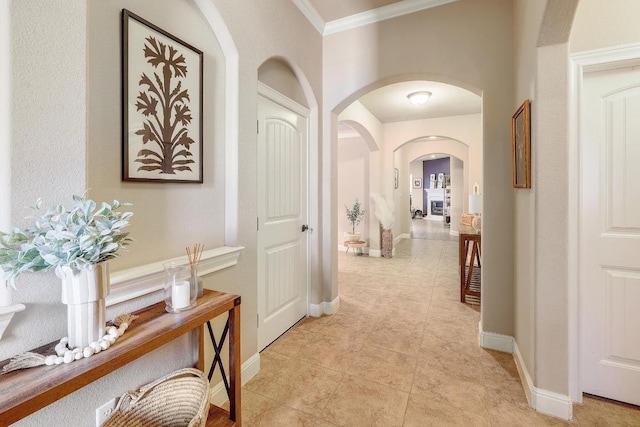 4408 Trinity Woods St, Leander, TX 78641 - hall with arched walkways, baseboards, crown molding, and light tile patterned floors