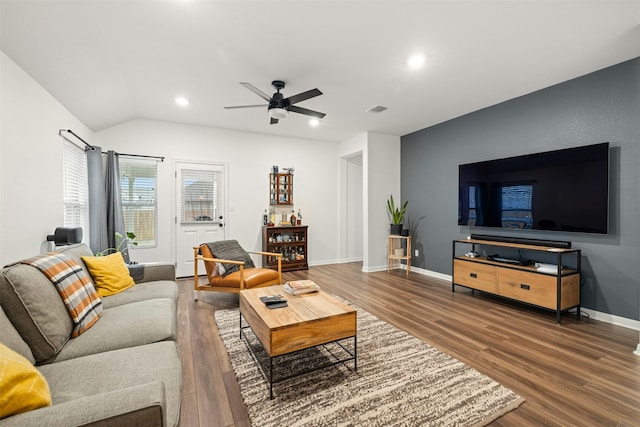 living room featuring ceiling fan, wood-type flooring, and vaulted ceiling