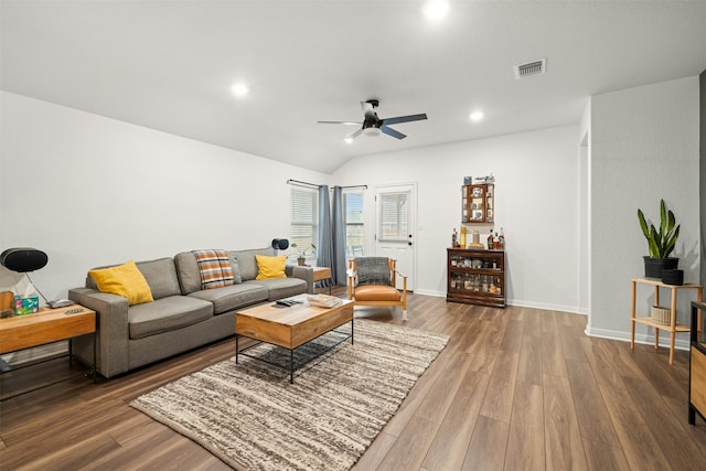 living room with ceiling fan, wood-type flooring, and lofted ceiling