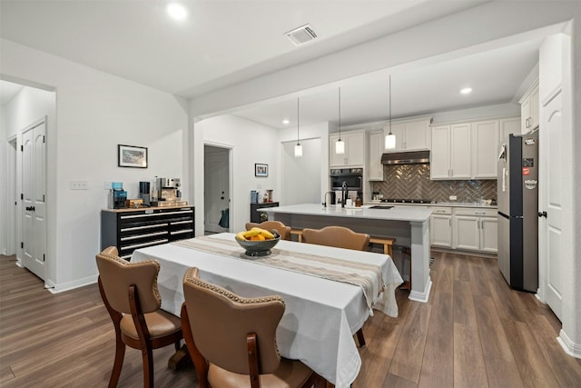 dining area with visible vents, recessed lighting, and dark wood-type flooring