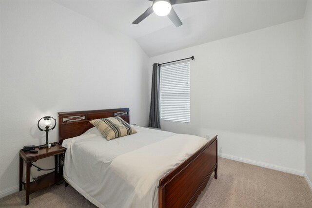 bedroom with light carpet, ceiling fan, baseboards, and lofted ceiling