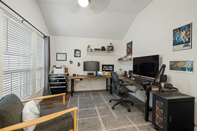 carpeted home office featuring ceiling fan, a healthy amount of sunlight, and vaulted ceiling