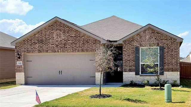 view of front of property featuring a garage and a front yard