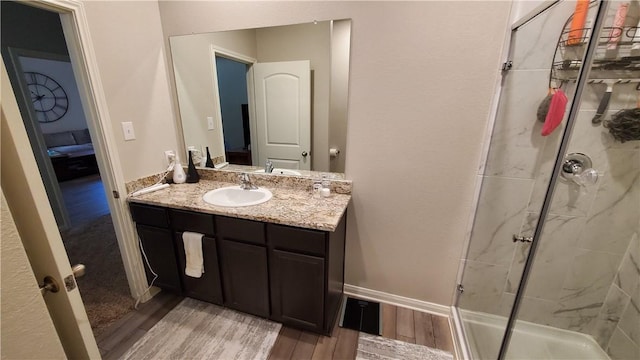 bathroom featuring walk in shower and vanity