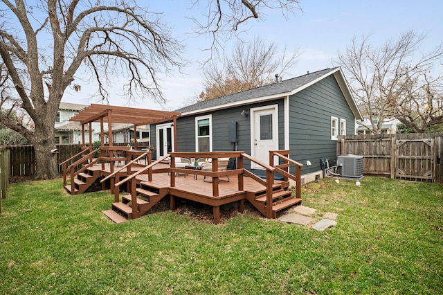 rear view of property with a wooden deck, central AC unit, a pergola, and a lawn