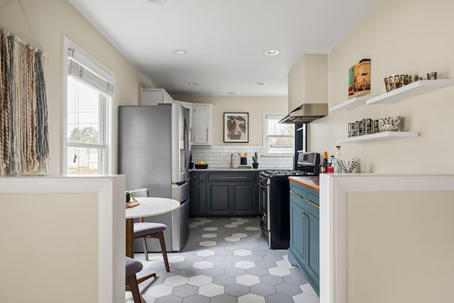 kitchen featuring sink, gray cabinetry, backsplash, stainless steel appliances, and island exhaust hood